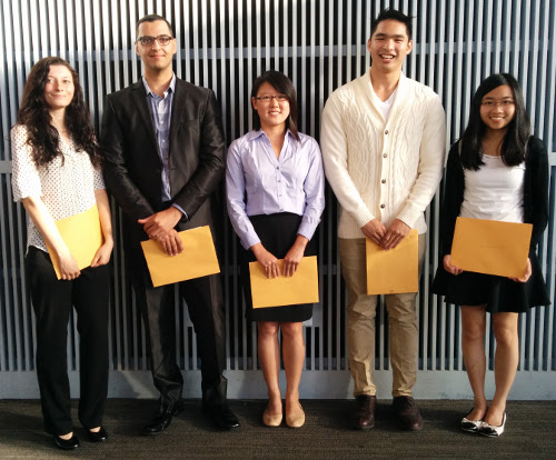 Five students standing in a row holding award envelopes